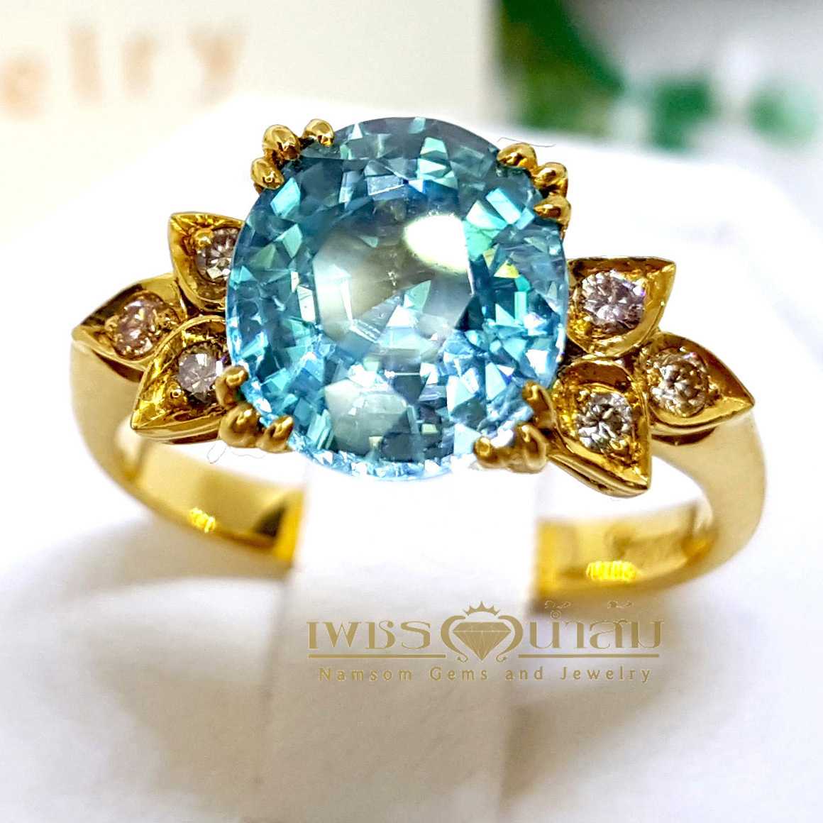 แหวนเพทาย Blue Zircon สีฟ้าสด เล่นลูกเล่นลายไทยทรงดอกประดับฝังด้วยเพชรแท้ บนตัวเรือนทองแท้ทั้งตัวเรือน