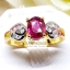 แหวนพลอยทับทิม Ruby สีเลือดนก ทรงหวานประดับตกแต่งด้วยเพชรแท้เป็นทรงใบไม้ไขว้ลายไทย บนตัวเรือนทองแท้ทั้งตัวเรือน