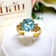 แหวนเพทาย Blue Zircon สีฟ้าสด เล่นลูกเล่นลายไทยทรงดอกประดับฝังด้วยเพชรแท้ บนตัวเรือนทองแท้ทั้งตัวเรือน